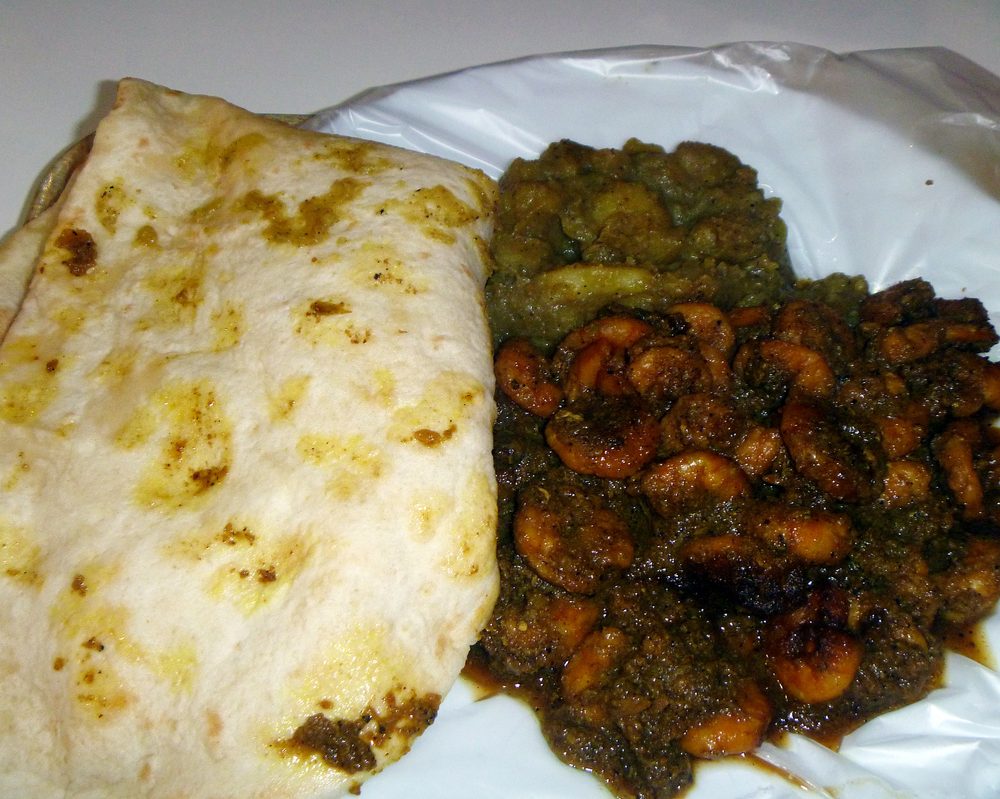 Curry roti plate wrapped with spiced curry filling on the side
